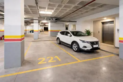 a white car parked in a parking lot at Affordable Luxury Apartment in Nouaseur