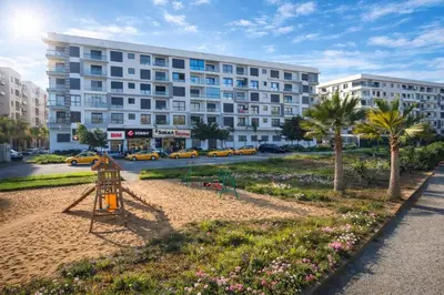 a playground in a park in front of a building at Affordable Luxury Apartment in Nouaseur