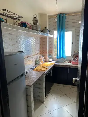 a kitchen with a refrigerator and a counter top at Cozy apartment in Mohammedia in Mohammedia