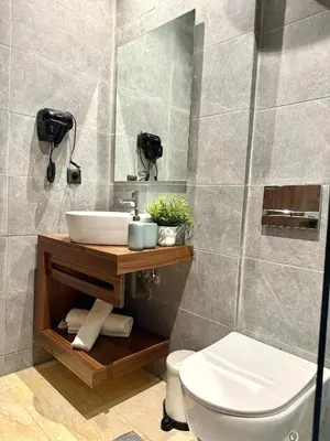 a bathroom with a sink and a toilet and a mirror at App Chic & Jacuzzi à Bourgogne près de la Corniche in Casablanca-Port