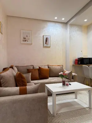 a living room with a couch and a table at App Chic & Jacuzzi à Bourgogne près de la Corniche in Casablanca-Port