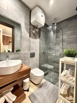 a bathroom with a sink and a toilet and a shower at App Chic & Jacuzzi à Bourgogne près de la Corniche in Casablanca-Port