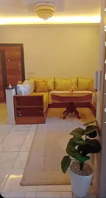 a living room with a couch and a table at Appartement moderne et confortable proche plages in Casablanca
