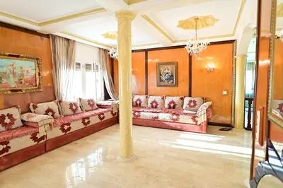a large living room with couches and a column at The 5-Suite Beachfront Villa in O Ben Slimane