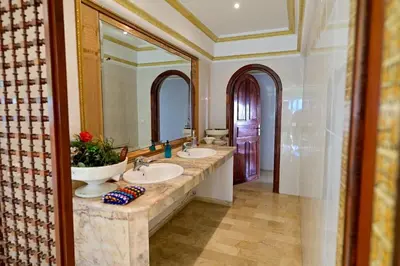 a bathroom with two sinks and a large mirror at The 5-Suite Beachfront Villa in O Ben Slimane