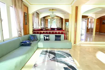 a living room with a blue couch in a room at The 5-Suite Beachfront Villa in O Ben Slimane