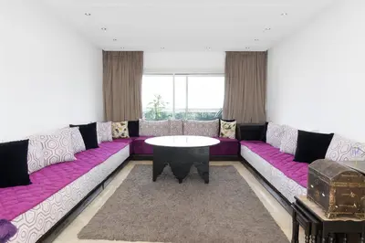 a living room with a purple couch and a table at Kridarek - Charming apartment with pool in Tamaris in Tamaris