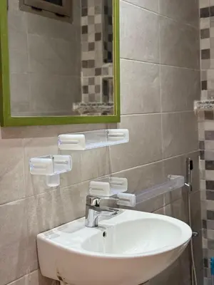 a bathroom with a white sink and a mirror at Appartement arome in Rabat