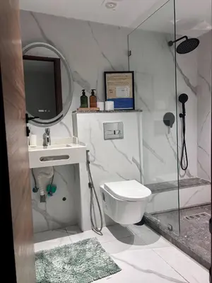 a bathroom with a toilet and a sink and a mirror at Elegant Studio - Quiet & Stylish in Casablanca