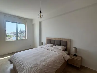 a bedroom with a large bed and a window at Atlantica in Rabat