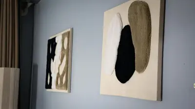 two pieces of art hanging on a wall at Yaqcha Home in Casablanca