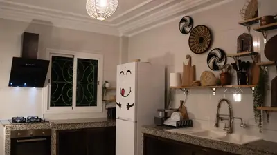 a kitchen with a white refrigerator and a sink at Yaqcha Home in Casablanca