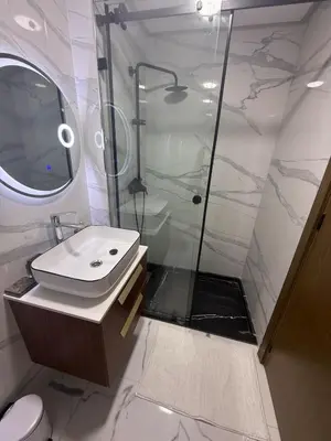 a bathroom with a shower and a sink and a toilet at Comfortable apartment in a gated community in Casablanca