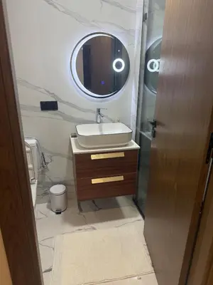 a bathroom with a sink and a mirror at Comfortable apartment in a gated community in Casablanca