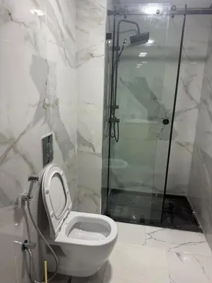 a bathroom with a white toilet and a shower at Comfortable apartment in a gated community in Casablanca