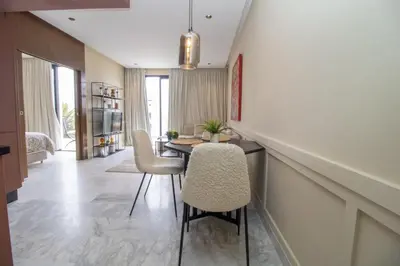 a dining room with a table and chairs at Beautiful Studio in Oasis - Gym access & Balcony & Free Parking & Wifi Fiber in Casablanca