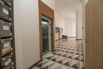 a hallway of an office building with a checkerboard floor at Elegant Studio in Maarif - Gym access & Free Parking & Wifi Fiber in Casablanca