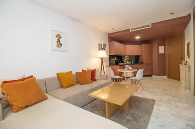 a living room with a couch and a table at Elegant Studio in Maarif - Gym access & Free Parking & Wifi Fiber in Casablanca