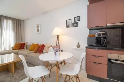 a living room with a couch and a table and chairs at Elegant Studio in Maarif - Gym access & Free Parking & Wifi Fiber in Casablanca