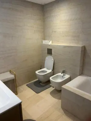 a bathroom with a toilet and a bidet and a sink at My Cosy Place Luxury 2BR Apartment CasaFinanceCity in Casablanca