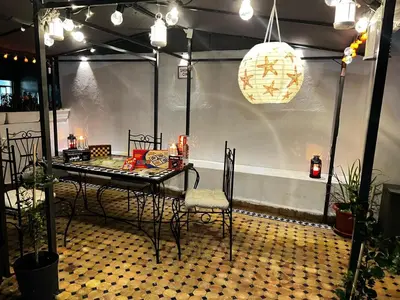 a room with a table and chairs on a floor at Lalla Mina Suite with large Terrace - Dar EL BAHIA in Casablanca