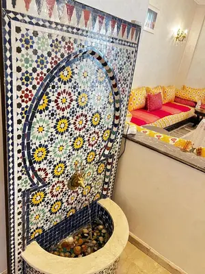 a bathroom with a mosaic wall with a bird in a fountain at Lalla Mina Suite with large Terrace - Dar EL BAHIA in Casablanca