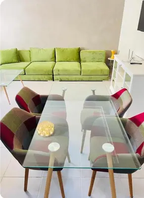 a living room with a couch and a glass table at Fal azure in Bouznika