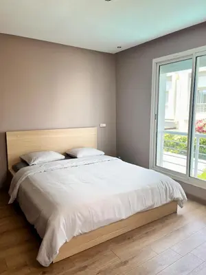 a bedroom with a large white bed with a window at Charming villa in a coastal area in Casablanca