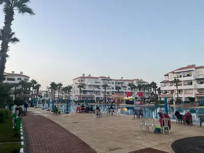 a group of apartment buildings next to a swimming pool at Garden beach 2 in Sidi Rahal