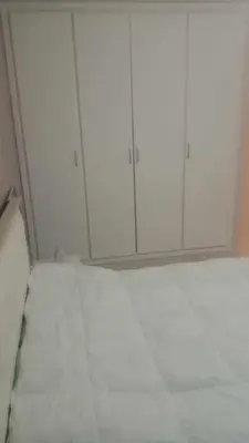a room with white cabinets in a room at Aicha Iliana in Bouznika