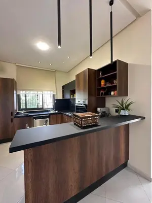 a large kitchen with a large island in the middle at la ferme du bonheur in Aïn el Apuda