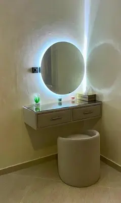 a vanity with a mirror and a stool in a bathroom at Superbe T3 ensoleillé avec Terrasse - 2 chambres - Casablanca in Casablanca