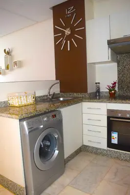 a kitchen with a washing machine in a kitchen at VIVASTAY Casablanca - Charming Studio Nouacer - 4 min Airport Mohamed V CMN in Nouaseur