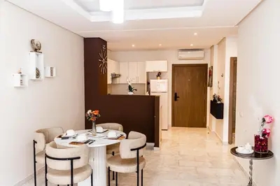 a kitchen and dining room with a table and chairs at VIVASTAY Casablanca - Charming Studio Nouacer - 4 min Airport Mohamed V CMN in Nouaseur