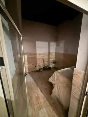 a room with a shower and a bed in it at Mandarona in Bouznika