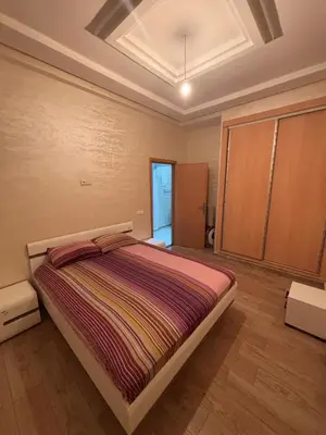 a bedroom with a large bed in a room at Mandarona in Bouznika