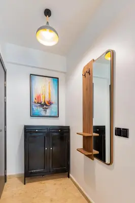 a bathroom with a black cabinet and a mirror at chic & cozy Apartment, Parc Serenity in Mohammedia