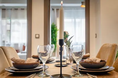 a table with a candle and wine glasses on it at chic & cozy Apartment, Parc Serenity in Mohammedia