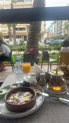 a table with a plate of food on a table at chic & cozy Apartment, Parc Serenity in Mohammedia