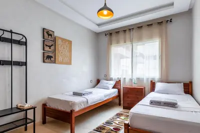 a bedroom with two beds and a window at chic & cozy Apartment, Parc Serenity in Mohammedia