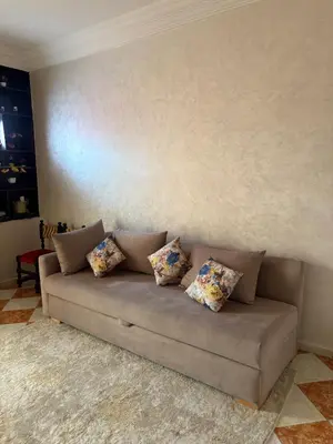 a couch in a living room with pillows on it at Summer sale two bedroom APT Near downtown in Casablanca