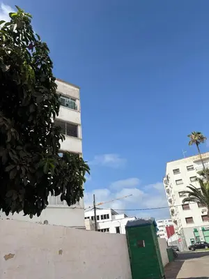 a tall building with a green dumpster in front of it at Summer sale two bedroom APT Near downtown in Casablanca