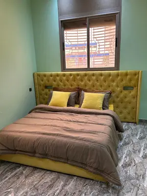a large bed in a bedroom with a window at Appartment calme a Ain Aouda in Aïn el Apuda