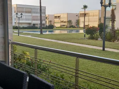 a view of a pool from a balcony of a building at Résidence balnéaire - Piscine Plage et Diverses in Sidi Rahal