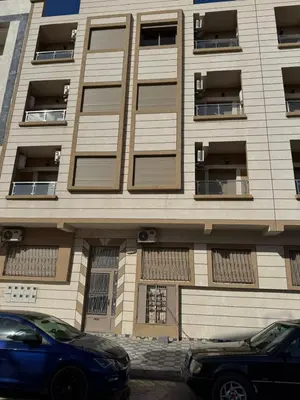 a building with windows and a blue car parked in front at Appartement à Dahomey - Bouznika in Bouznika