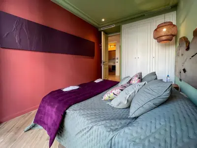a bedroom with a large bed with purple sheets and pillows at Maya Suites - Premium Luxury Stay in Casablanca