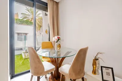 a dining room with a glass table and chairs at 1- Bourgogne City Escape in Casablanca