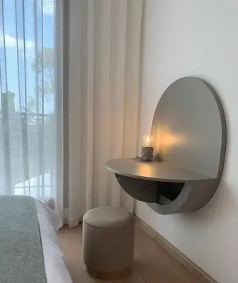 a bedroom with a table and a mirror on the wall at Villa Moderne et élégante Piscine Golf Resort in Casablanca