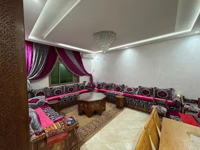 a living room with couches and a table at 3 bedroom apartment with living room and terrace 90metre in El Harhoura
