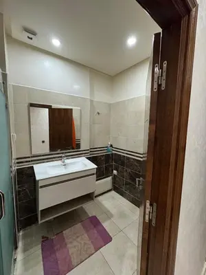 a bathroom with a sink and a mirror at 3 bedroom apartment with living room and terrace 90metre in El Harhoura